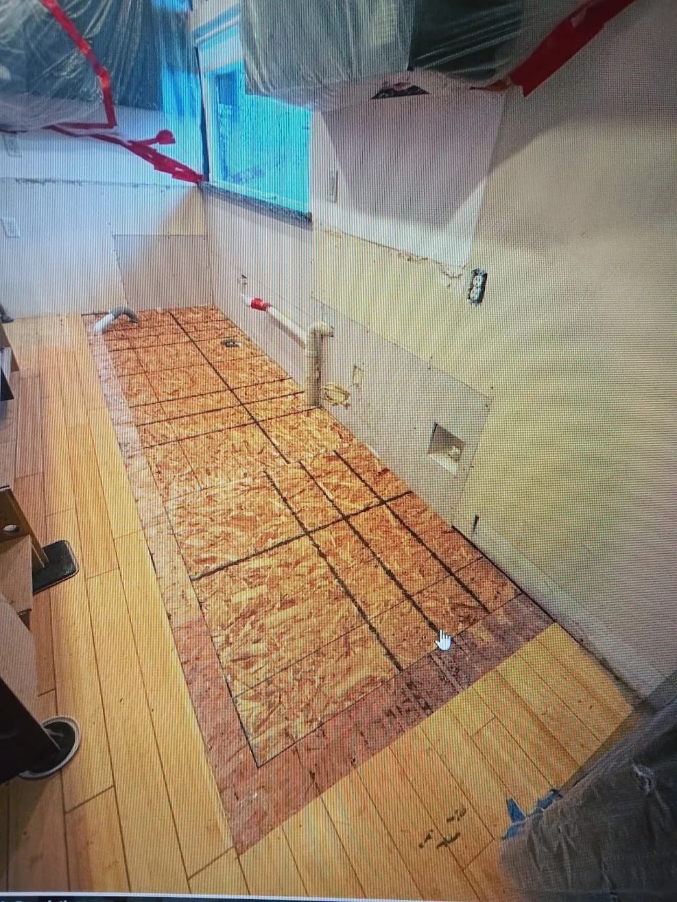 Room stripped back to bare subfloor and framing during water damage reconstruction