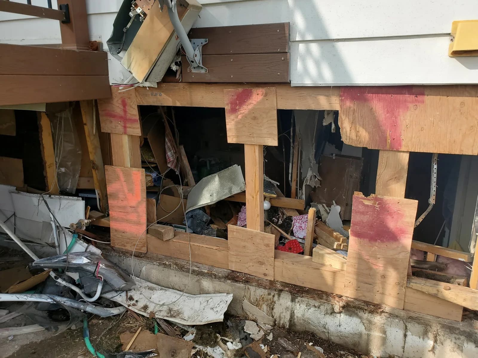 Interior wall opened to framing and insulation to assess hidden storm and water damage